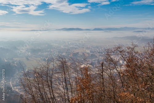 Kamnik town and valley covered with translucent morning mist.