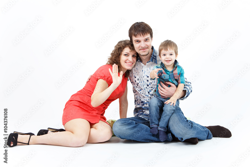 Happy family with child posing on white background Happy family with child posing on white background