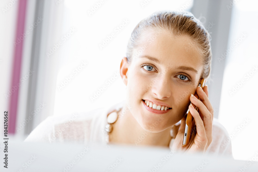 Attractive office worker sitting at desk Attractive office worker sitting at desk