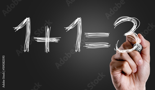 Hand writing the text: 1+1=3