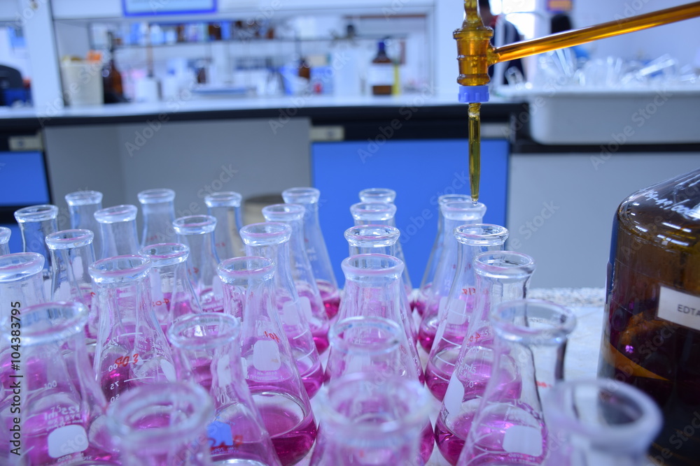 Scientist Working At Laboratory ,Titration is a common laboratory