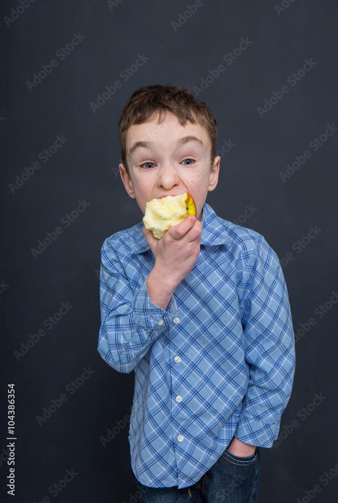 Cheerful smiling boy eat apple
Cheerful smiling boy eat apple