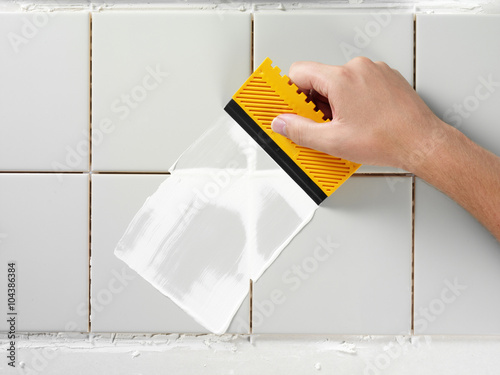 TILING AND GROUTING A WALL photo