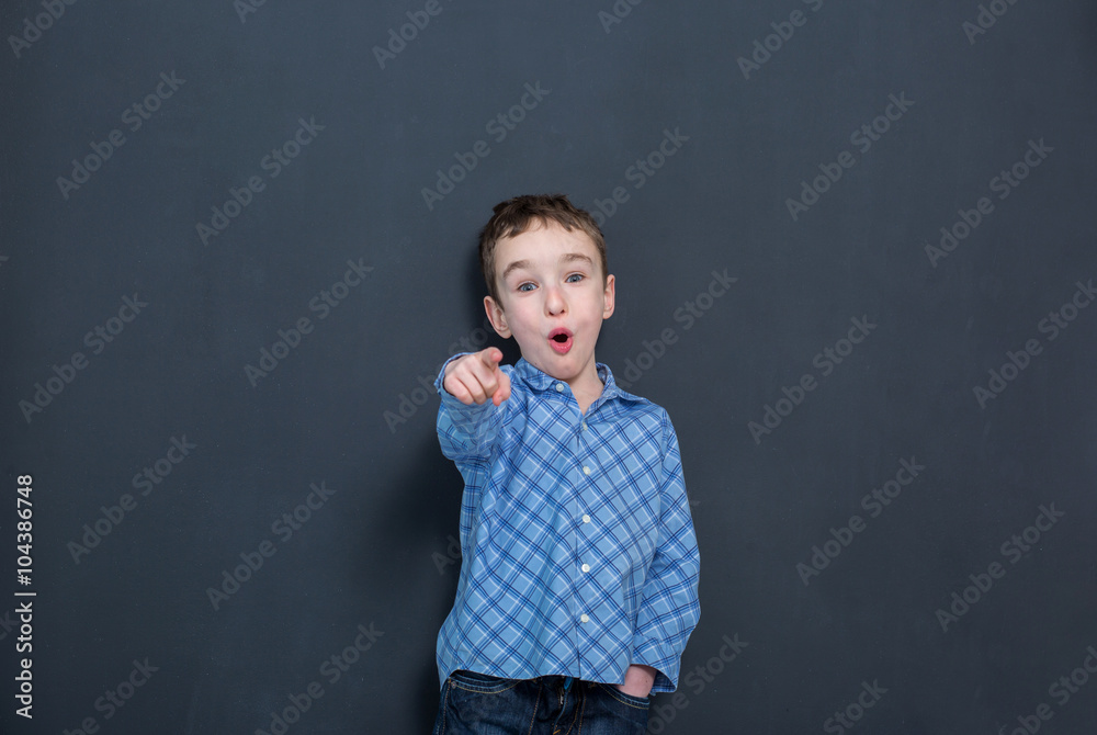 Cheerful smiling child at the blackboard
