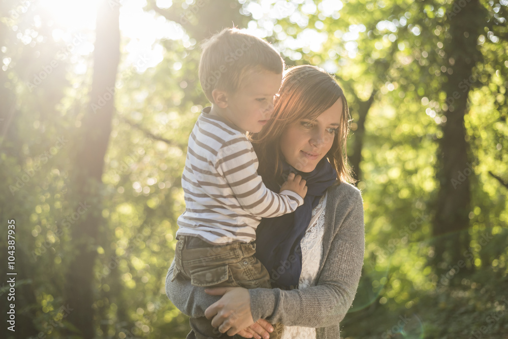 Mother with little son on her arms at backlight Mother with little son on her arms at backlight