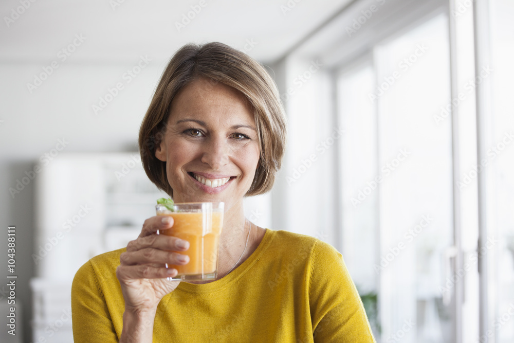 Portrait of smiling woman with a smoothie Portrait of smiling woman with a smoothie