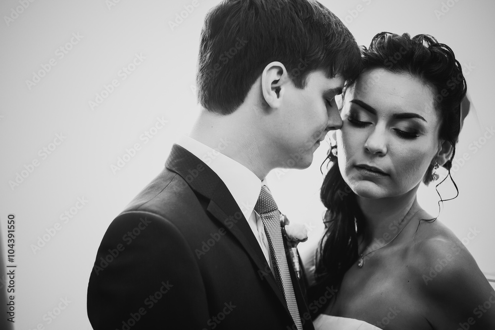 Black white photography beautiful young couple standing near the window Black white photography beautiful young couple standing near the window