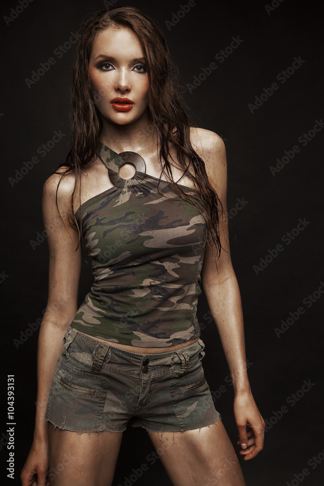 Brunette model with gun posing Brunette model with gun posing