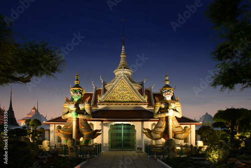 Thailand, Bangkok - couple of demon guardian gatekeepers at the Wat Arun temple of dawn during sunset
