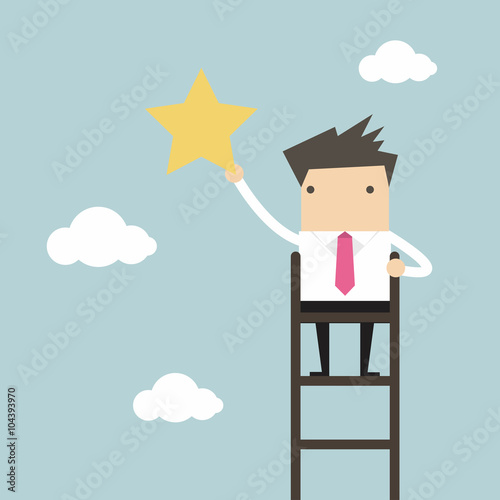 Businessman on a ladder grab star in the sky