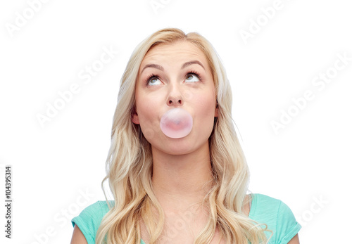 happy young woman or teenage girl chewing gum