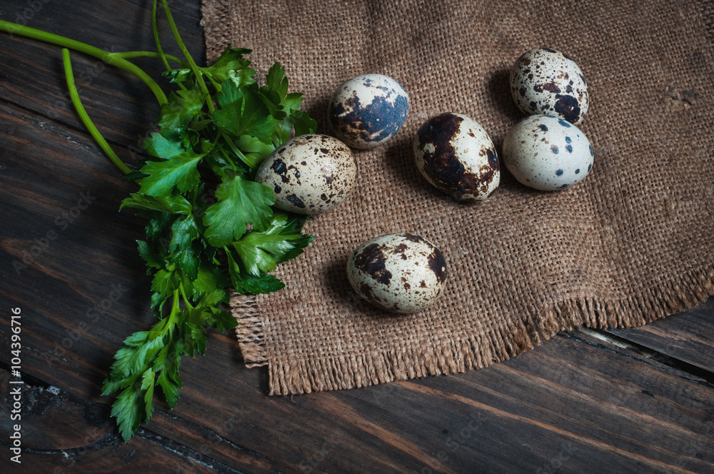 Quail eggs with parsley on a wooden table