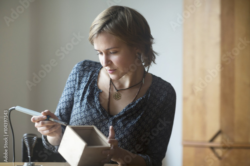 Young woman soldering something