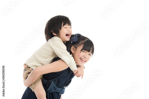  girl giving her brother piggyback ride