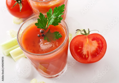 glass of fresh tomato juice on white background