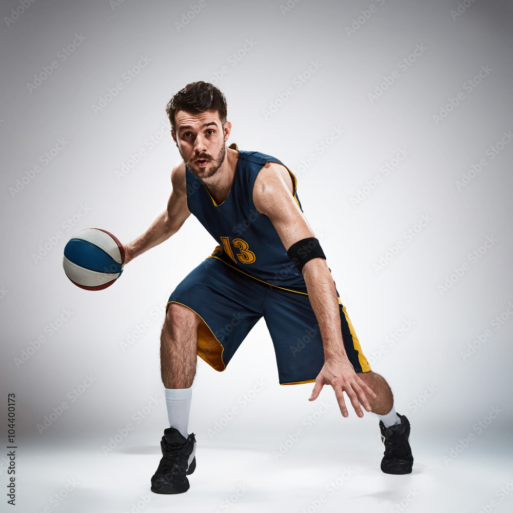 Fototapeta premium Full length portrait of a basketball player with ball 