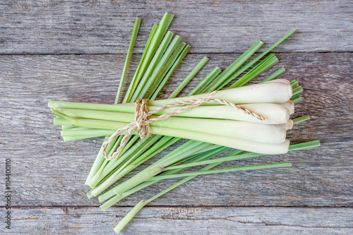 Fresh lemongrass (citronella) on wooden background - Spice for h photo