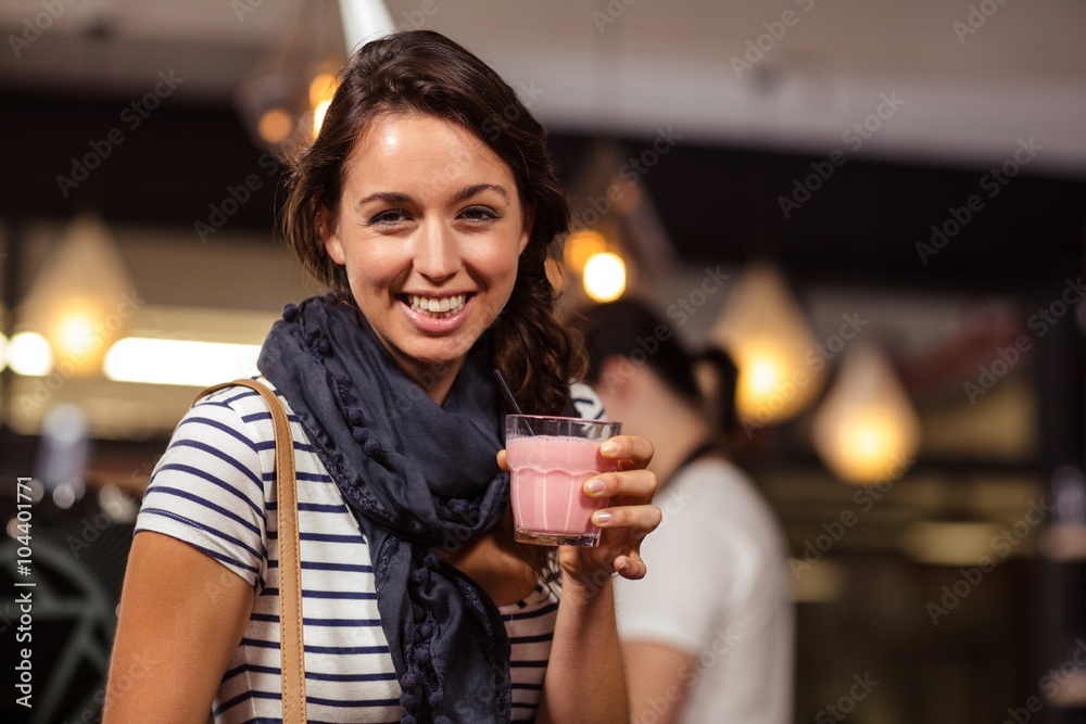 Smiling brunette drinking a beverage at the coffee shop Smiling brunette drinking a beverage at the coffee shop