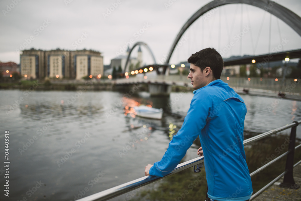 Spain, Naron, athlete contemplating the sea at twilight Spain, Naron, athlete contemplating the sea at twilight