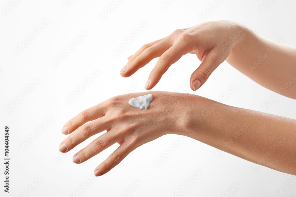 Closeup shot of beautiful female hands with cream Closeup shot of beautiful female hands with cream