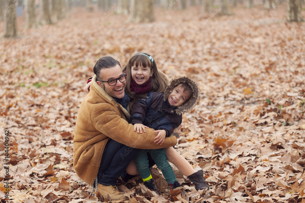 Father with happy children in park, autumn Father with happy children in park, autumn
