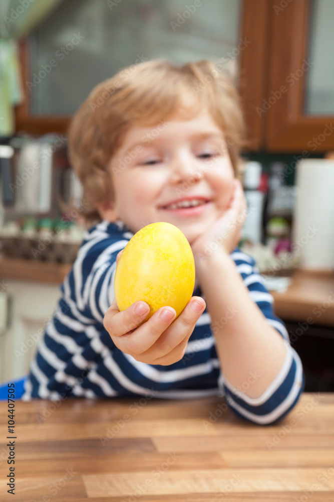 Fototapeta premium Small boy with yellow Easter egg.