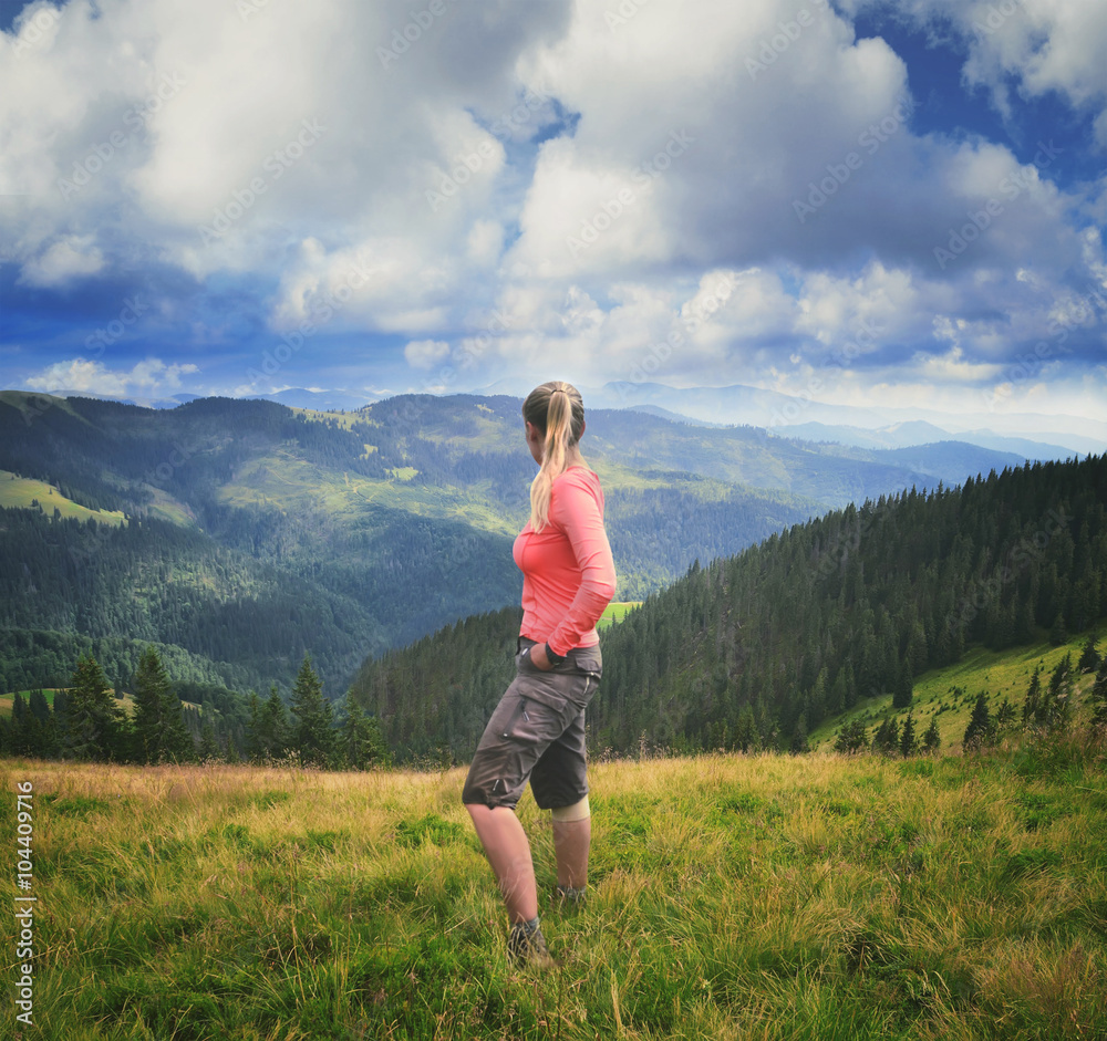 Woman hiker on a top of a mountain in Carpathian mountains Woman hiker on a top of a mountain in Carpathian mountains