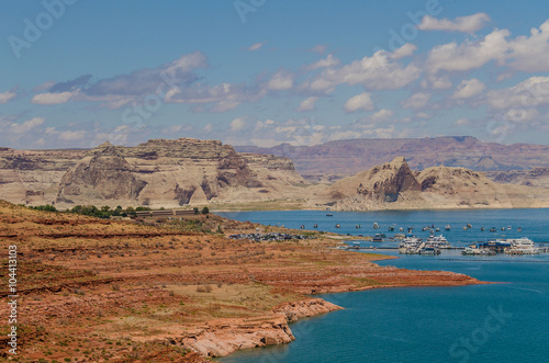 Overlooking a sunny day at Lake Powell with many boats and canyon in the background