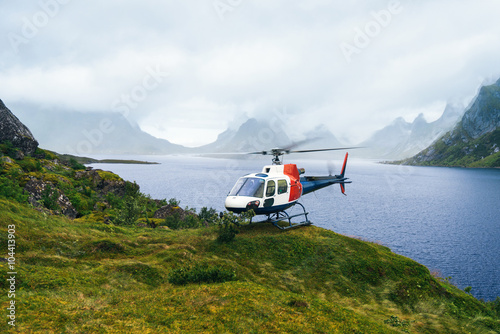 Helicopter in the great Norwagian mountains in cloudy weather. Reine, Lofotens photo