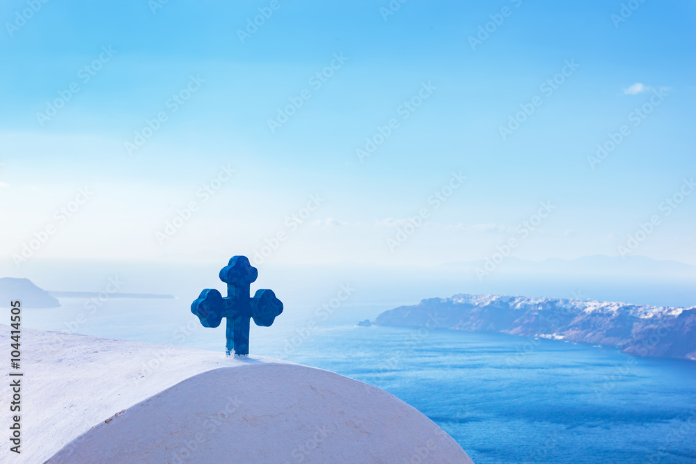 Blue cross on the church roof in Fira on Santorini island, Greece. Aegean sea. view - obrazy, fototapety, plakaty 