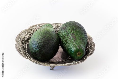 Avocados in silver plate