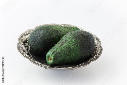 Avocados in silver plate