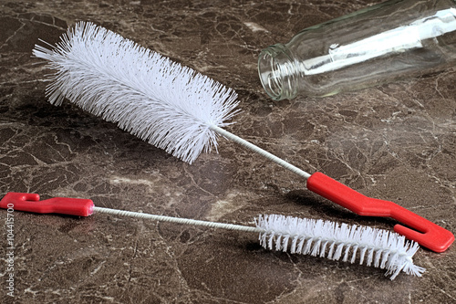  Brushes for cleaning bottle. 
 Brushes for cleaning bottle on a background of brown tiles
