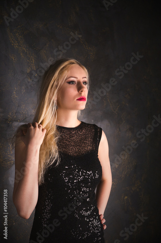 blond woman in a long black evening dress