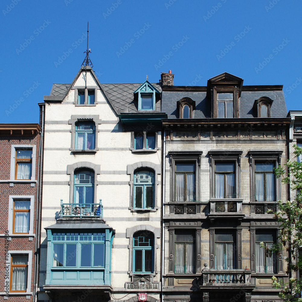 Eclectic old buildings and architectural details, such as windows, attics, balconies in the city of Liege, Belgium.