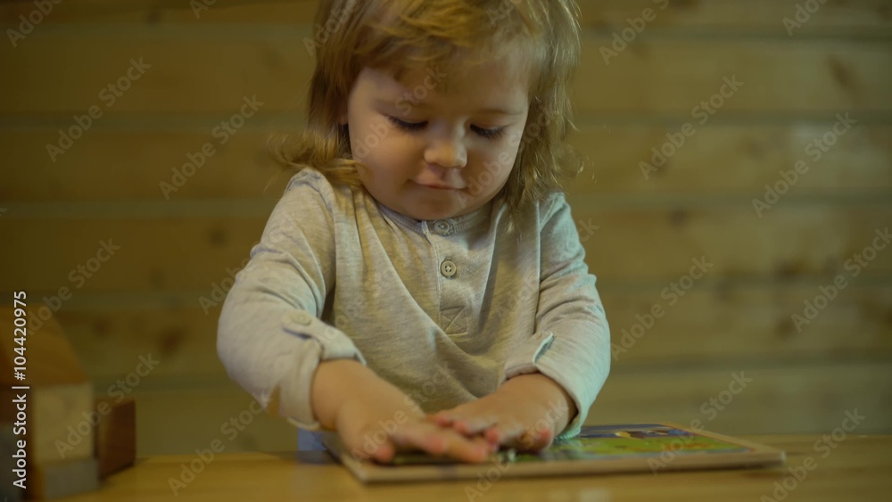 father helps the child lay down wooden puzzle at the table father helps the child lay down wooden puzzle at the table