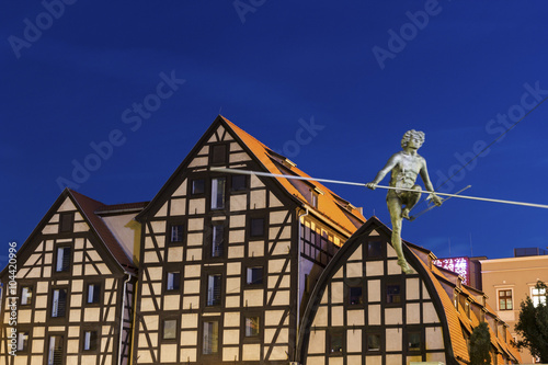 Statue on the rope and old Granaries in Bydgoszcz, Poland