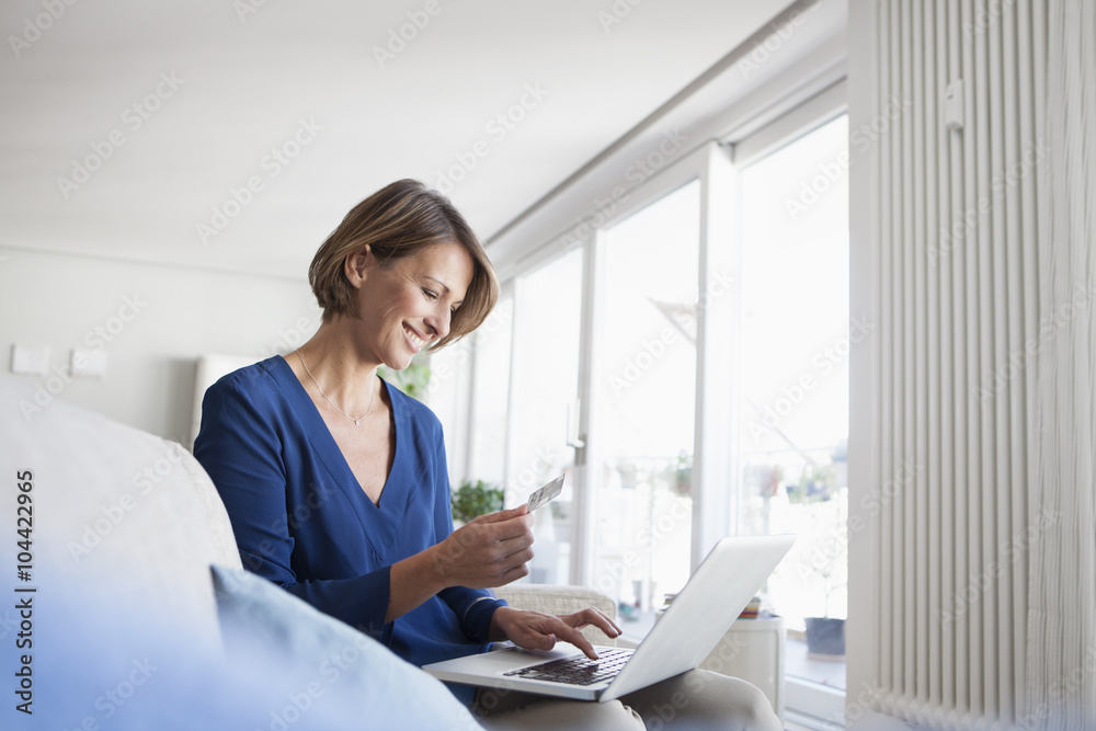 Smiling woman at home shopping online Smiling woman at home shopping online