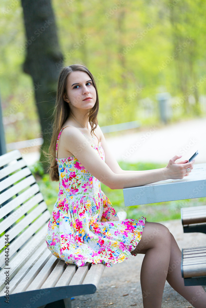 Young woman use cell phone in spring park Young woman use cell phone in spring park