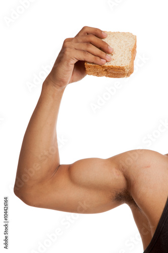 Muscular Asian man's arm  flexing biceps with bread