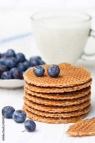 Stack  of Dutch caramel waffles with blueberry and cup of milk
