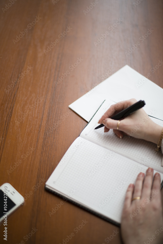 she writes pen on a pad