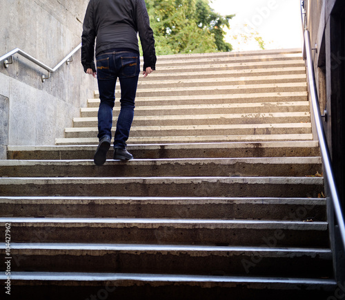 Man walking the stairs into bright light