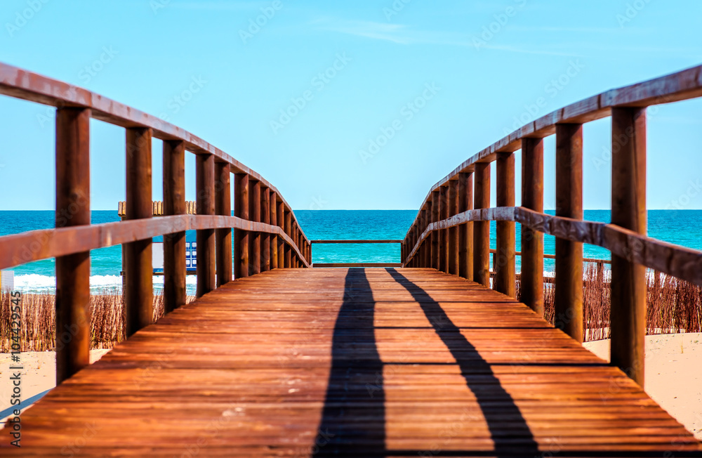 Wooden boardwalk to the beach. Idyllic scene