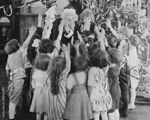 Santa Claus with group of excited children 