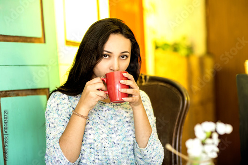 Young woman with a cup of coffee in the morning
