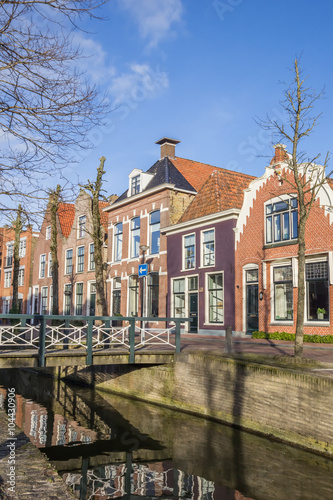Fototapeta Naklejka Na Ścianę i Meble -  Colorful houses and a bridge at a canal in Franeker