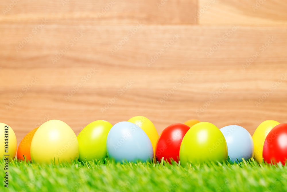 Easter eggs on grass and wood background as macro