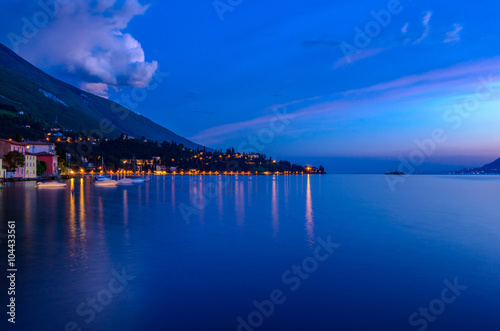 Tranquil sunset and evening illuminations of the beautiful town of Malcesine on Lake Garda in Italy.