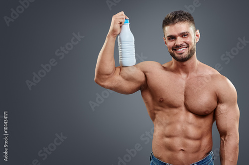 Athletic Man Fitness Model holding bottle
